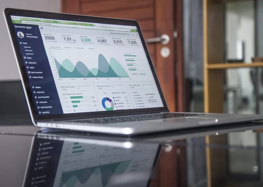 Analytics dashboard and laptop representing strategic market intelligence