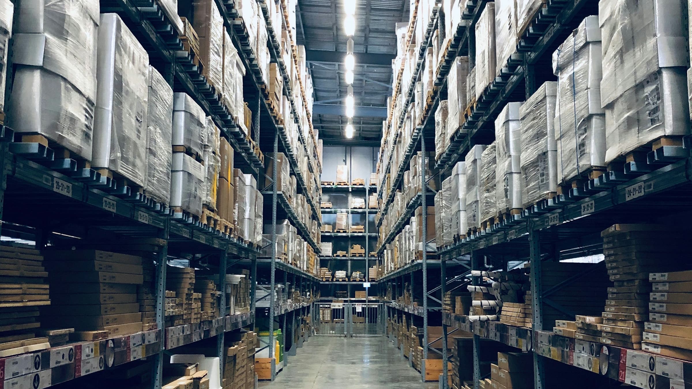 Industrial warehouse with forklifts moving inventory